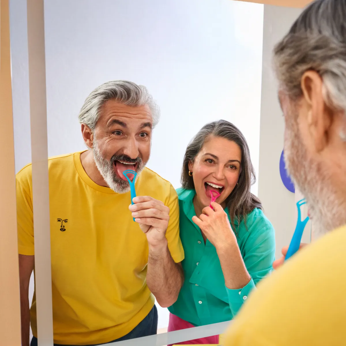Couple using tongue scraper