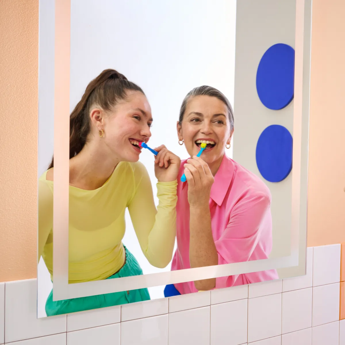 Two women brushing teeth
