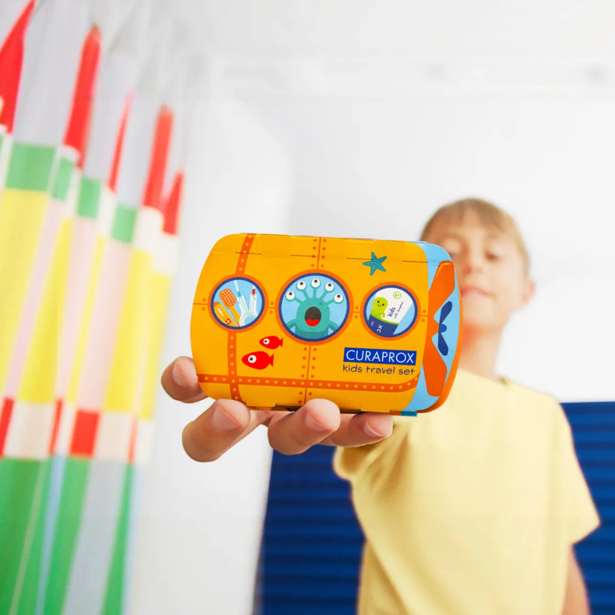 Child holding travel set